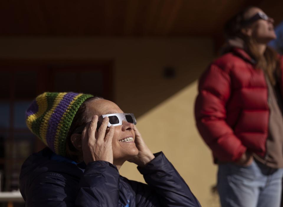 Jill Baillie and Courtney Henley watch an annular solar eclipse in Torrey, Utah, on Saturday, Oct. 14, 2023. A phenomenon known as the “ring of fire” was visible because of the way the sun’s edges perfectly surround the moon. | Laura Seitz, Deseret News