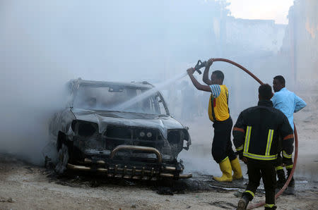 Fire fighters attempt to extinguish a burning car after an explosion in Mogadishu, Somalia September 22, 2018. REUTERS/Feisal Omar
