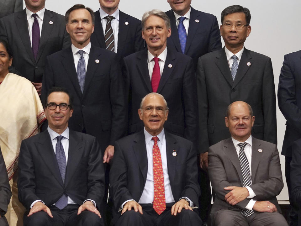 U.S. Treasury Secretary Steven Mnuchin, left bottom, and China's Finance Minister Liu Kun, right top, pose with other participants for a family photo of the G20 finance ministers and central bank governors meeting Sunday, June 9, 2019, in Fukuoka, western Japan. (AP Photo/Eugene Hoshiko)