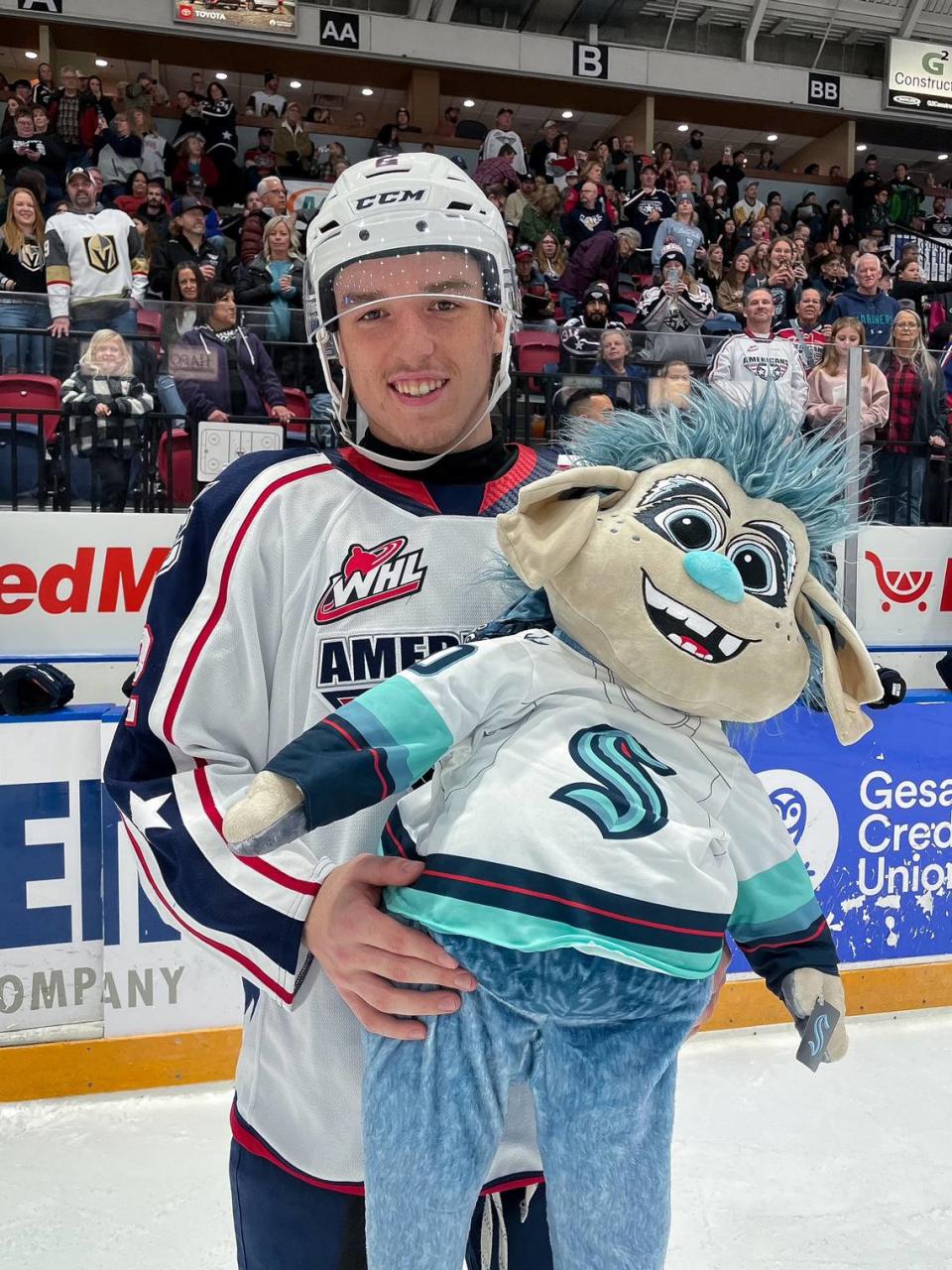 Defensemen Lukas Dragicevic, 18-year-old prospect for the Seattle Kraken, poses for a picture with a stuffed Bouy, the Kraken mascot, after the plushie was donated in the Tri-City Americans’ 23rd Teddy Bear Toss. Dragicevic scored the first goal of the night before the game reached its 6-minute mark.