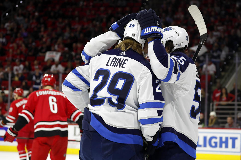 The Winnipeg Jets celebrate a goal by Patrik Laine (29) against the Carolina Hurricanes during the first period of an NHL hockey game in Raleigh, N.C., Tuesday, Jan. 21, 2020. (AP Photo/Karl B DeBlaker)