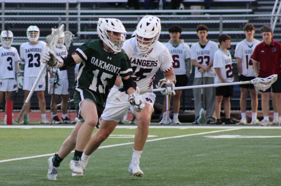 Jack Norris of Oakmont carries the ball in a game against Westborough on May 9, 2024. Norris scored the winning goal in double overtime to send the Spartans past Westborough, 5-4.