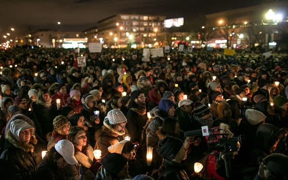 People gather to pay respect to the victims of the Quebec City mosque shooting. Photo from Getty Images.