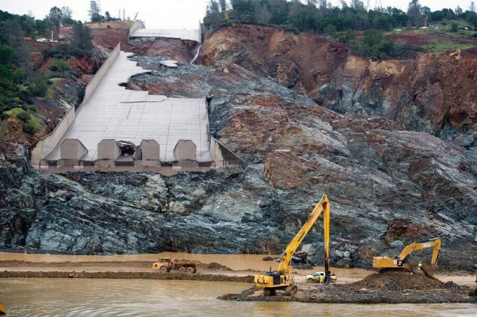 The wreckage of the main spillway at Oroville Dam in February 2017 left tons of concrete and other debris piled up in the Feather River below. The state plans to open the rebuilt spillway Tuesday.