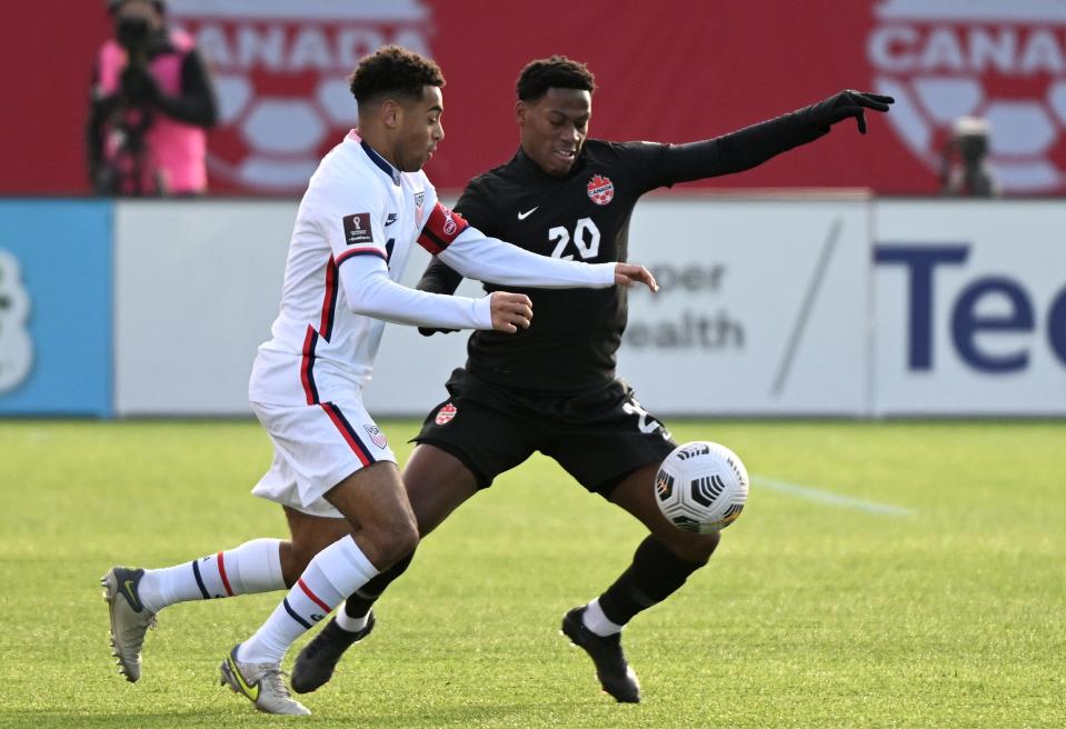 Jan 30, 2022; Hamilton, Ontario, CAN; Canada forward Jonathan David (20) battles for the ball with United States midfielder Tyler Adams (4) during a CONCACAF FIFA World Cup Qualifier soccer match at Tim Hortons Field.