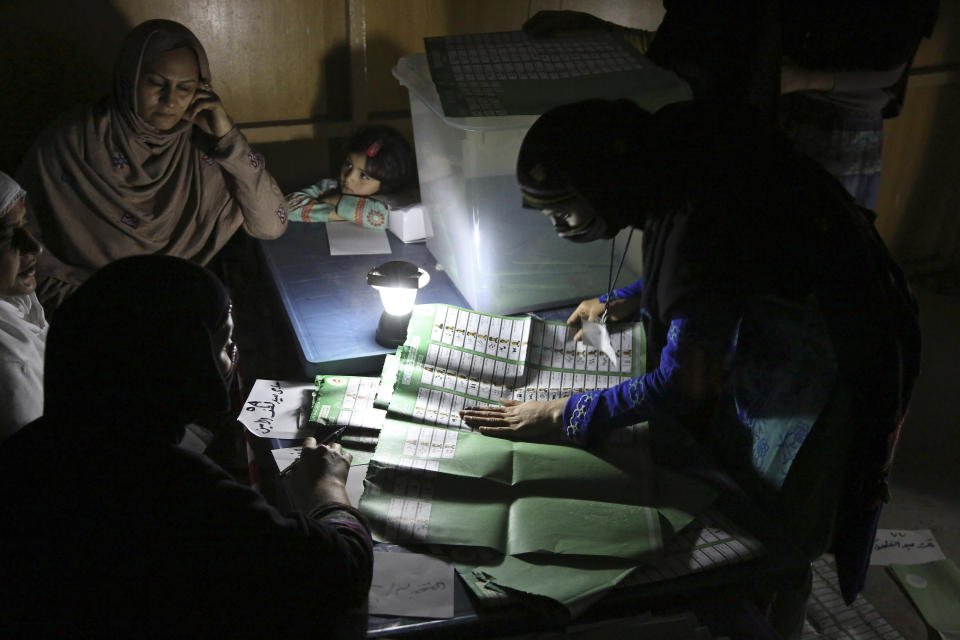 Afghan election workers count ballots by the light of a lantern at a polling station in Jalalabad, east of Kabul, Afghanistan, Saturday, April 5, 2014. Across Afghanistan, voters turned out in droves Saturday to cast ballots in a crucial presidential election. The vote will decide who will replace President Hamid Karzai, who is barred constitutionally from seeking a third term. Partial results are expected as soon as Sunday. (AP Photo/Rahmat Gul)