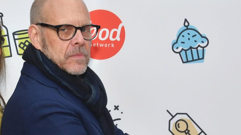 Alton Brown beside Food Network sign 