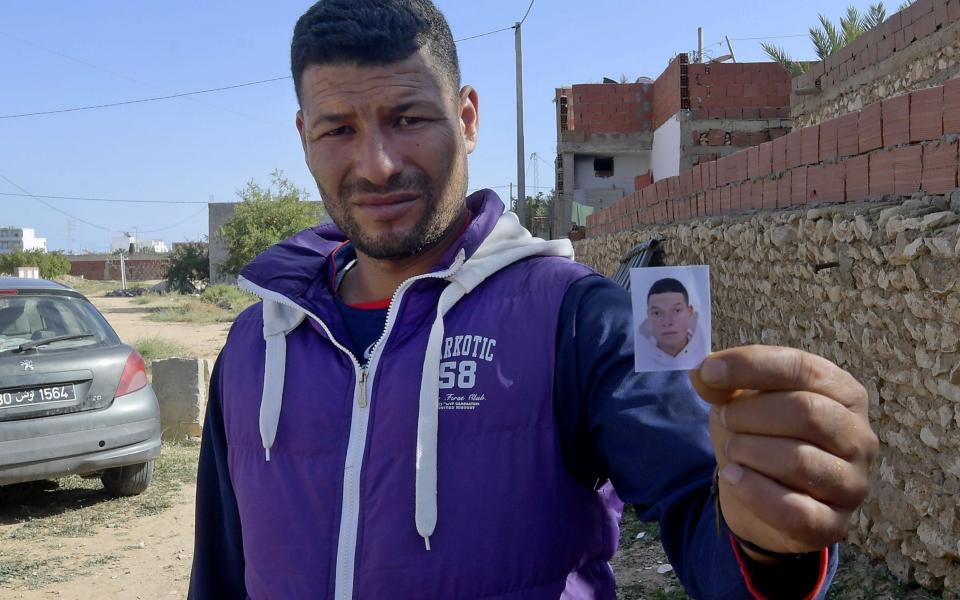 Yasin, the brother of the Nice assailant Brahim Aouissaoui, who a day earlier killed three people and wounded several others in the southern French city of Nice, shows his picture in front of the family home in the Tunisian city of Sfax, on October 30, 2020. - The knife attacker killed three people, cutting the throat of at least one woman, inside a church in Nice on the French Riviera. (Photo by Fethi Belaid / AFP) (Photo by FETHI BELAID/AFP via Getty Images) - Fethi Belaid/AFP via Getty Images