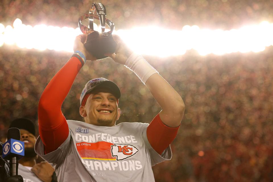 Patrick Mahomes holds up the Lamar Hunt Trophy after defeating the Bengals 23-20 in the AFC Championship Game.