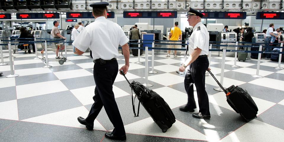 Airline Pilots walk through a terminal at ORD.