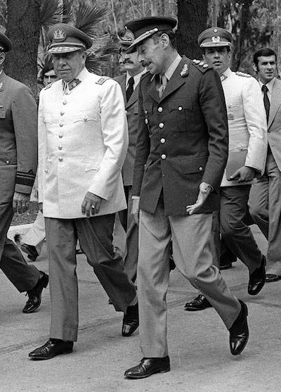 Argentina’s dictator Gen. Jorge Rafael Videla, right, confers with Chile’s Gen. Augusto Pinochet, in Mendoza, Argentina, in 1978. <a href="https://newsroom.ap.org/detail/ObitArgentinaVidela/5da45b83d8f74a63bee16d422fc13b9f/photo?boardId=37be9465fcce45d283d5431cccb20a6a&st=boards&mediaType=audio,photo,video,graphic&sortBy=&dateRange=Anytime&totalCount=484&currentItemNo=3" rel="nofollow noopener" target="_blank" data-ylk="slk:AP Photo/Eduardo Di Baia;elm:context_link;itc:0;sec:content-canvas" class="link ">AP Photo/Eduardo Di Baia</a>