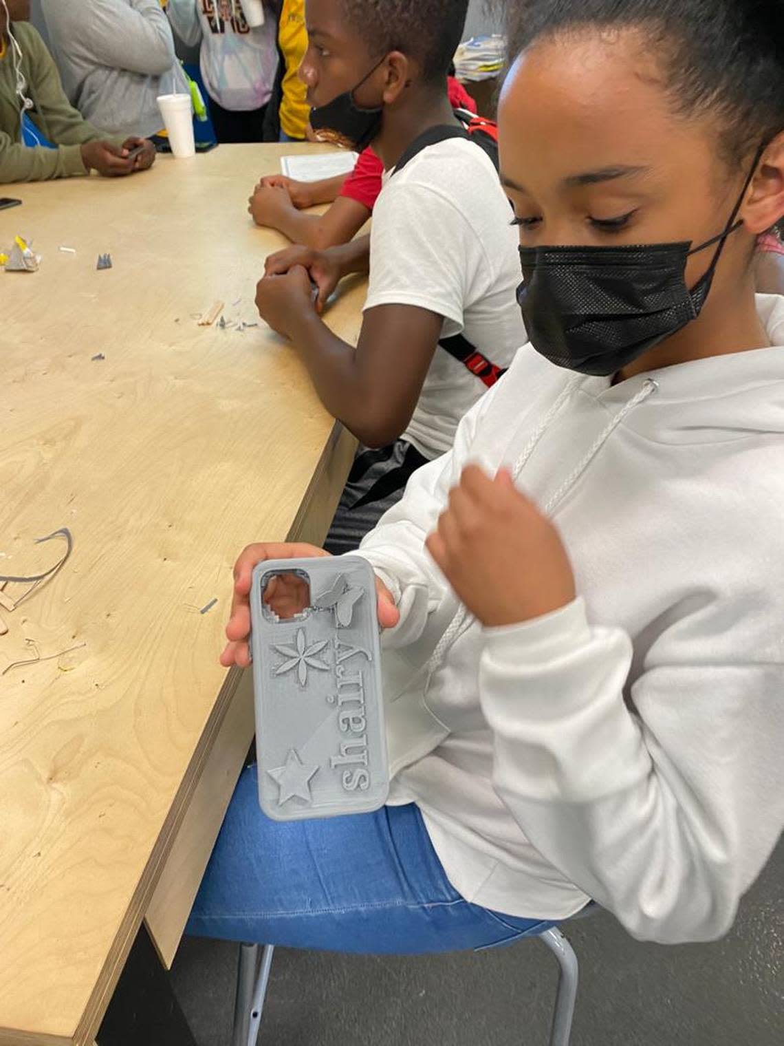 A young teen from Liberty City Optimist Club demonstrates her new 3D printed cell phone case that she designed. The Fab Lab Miami STEAM program is funded by The Children’s Trust.
