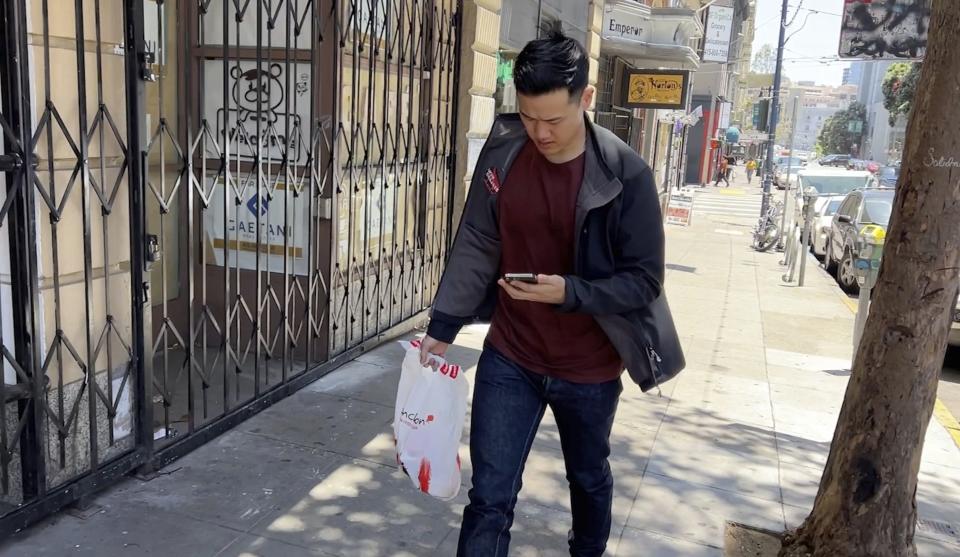 Andy Fang, DoorDash’s co-founder and chief technology officer, picks up and delivers food orders to customers in downtown San Francisco on Saturday, June 15, 2023. Fang is one of a growing number of executives who work shifts on the front lines of the companies they run. All DoorDash salaried employees are required to make deliveries or work directly with customers or merchants several times a year. (AP Photo/Terry Chea)