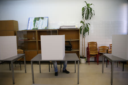 A man votes during presidential and parliamentary elections at a polling centre at a school in Crkvice near Zenica, Bosnia and Herzegovina October 7, 2018. REUTERS/Dado Ruvic