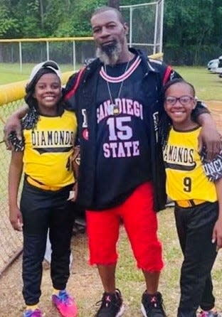 Haynesville native Bobby Ray Tell stands with his daughters, A'lajah and Brajah Tell, following one of their athletic contests. Tell died Wednesday in Haynesville.