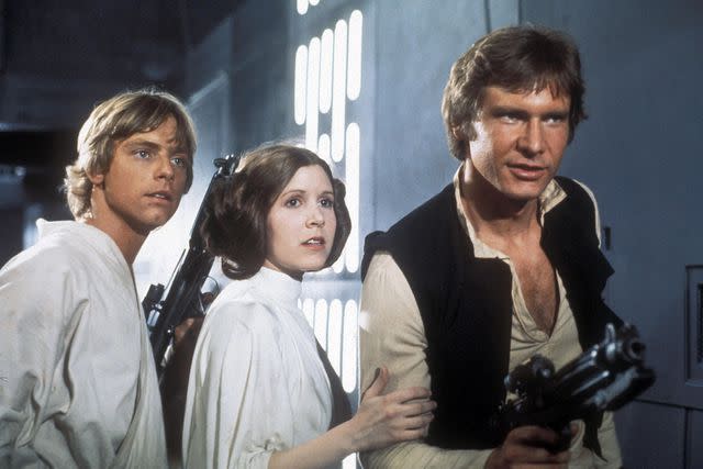 <p>Allstar Picture Library Limited. / Alamy</p> Mark Hamill as Luke Skywalker, Carrie Fisher as Princess Leia and Harrison Ford as Han Solo in 'STAR WARS: EPISODE IV - A NEW HOPE', 1977