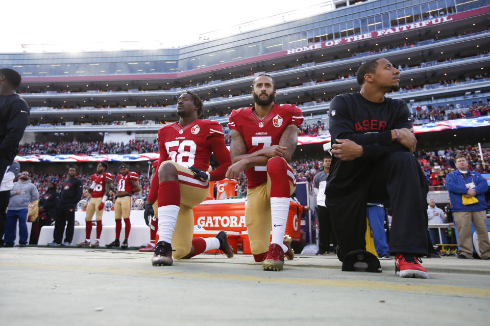 SANTA CLARA, CA - JANUARY 1: Eli Harold #58, Colin Kaepernick #7 and Eric Reid #35 of the San Francisco 49ers kneel on the sideline, during the anthem, prior to the game against the Seattle Seahawks at Levi Stadium on January 1, 2017 in Santa Clara, California. The Seahawks defeated the 49ers 25-23. (Photo by Michael Zagaris/San Francisco 49ers/Getty Images) 