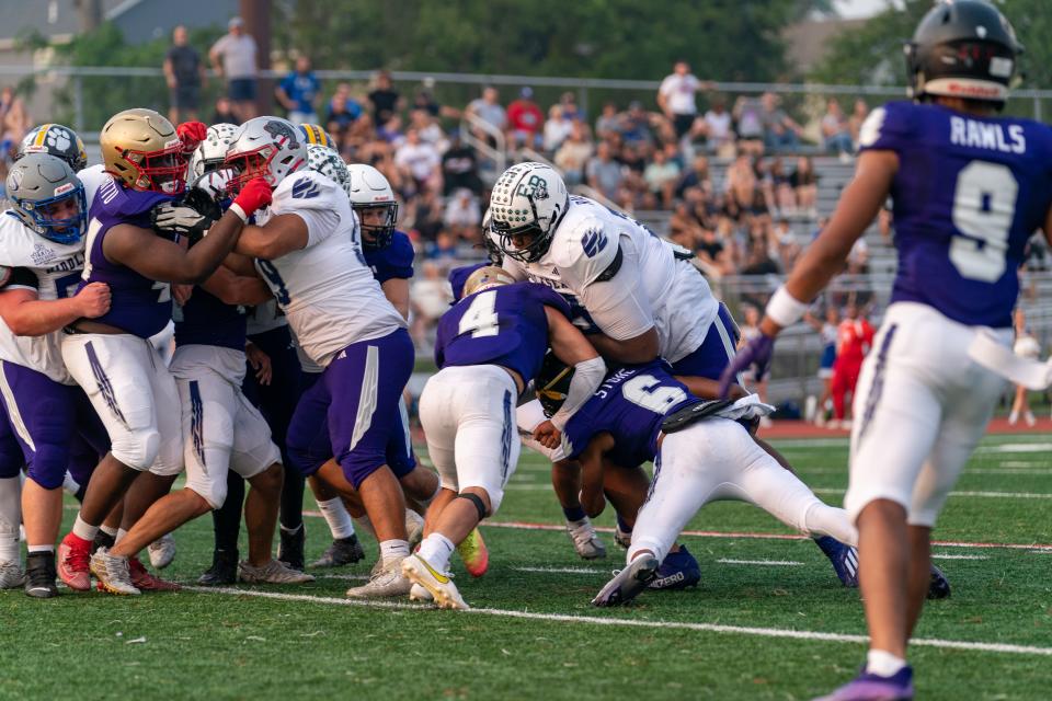 Omar Rackley (center, white jersey) blocks in the Bellamy and Sons Paving Marisa Rose Bowl on June 29, 2023