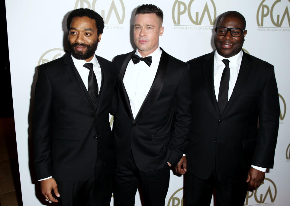 Steve McQueen, right, Chiwetel Ejiofor, left, and Brad Pitt arrive at the 25th annual Producers Guild of America Awards at the Beverly Hilton Hotel in Beverly Hills, Calif. on Sunday, Jan. 19, 2014. (Photo by Matt Sayles/Invision/AP)