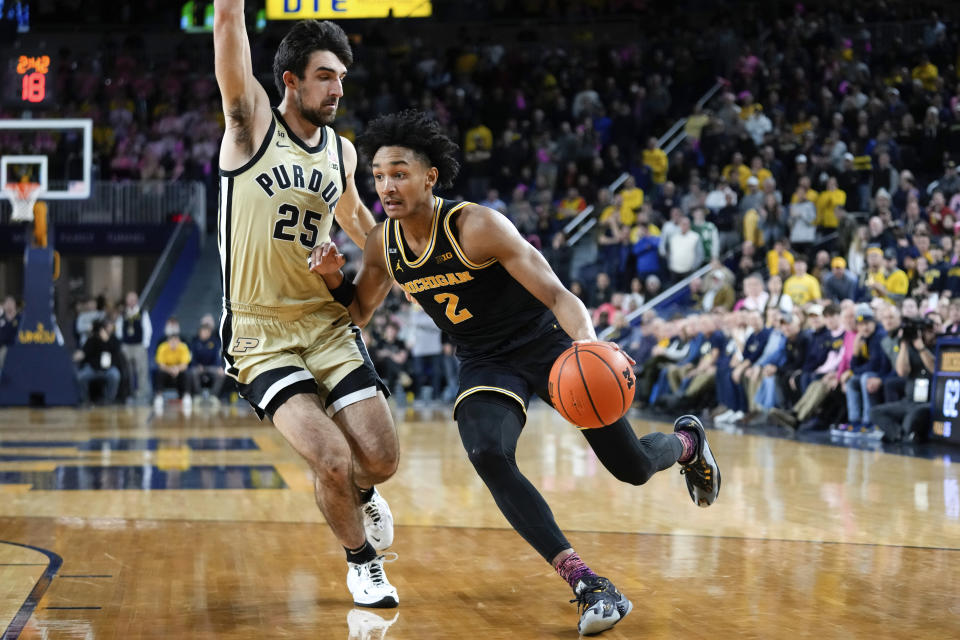 Michigan guard Kobe Bufkin (2) drives on Purdue guard Ethan Morton (25) in the second half of an NCAA college basketball game in Ann Arbor, Mich., Thursday, Jan. 26, 2023. (AP Photo/Paul Sancya)