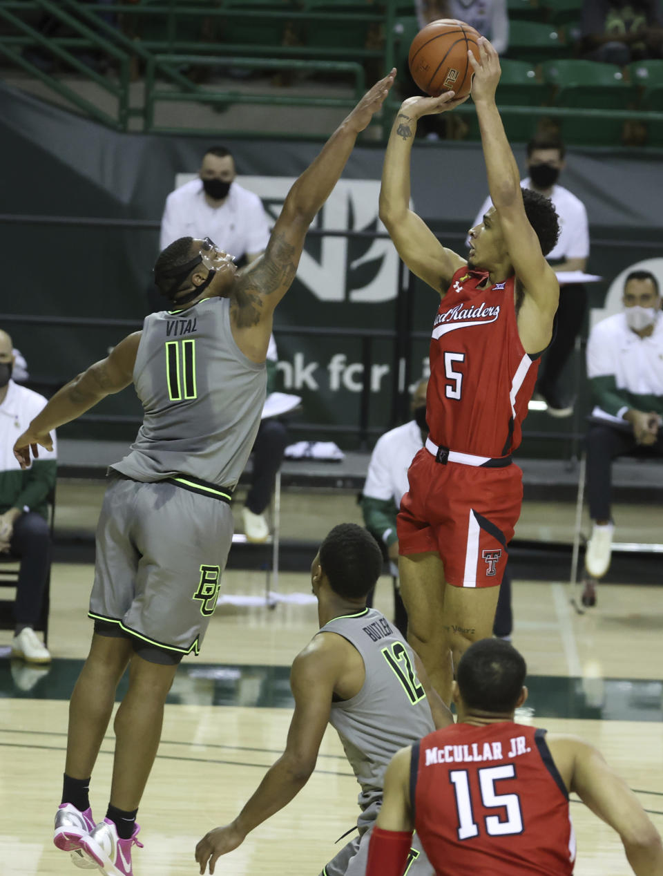 Texas Tech guard Micah Peavy (5) attempts a shot over Baylor guard Mark Vital (11) in the first half of an NCAA college basketball game Sunday, March 7, 2021, in Waco, Texas. (AP Photo/Jerry Larson)