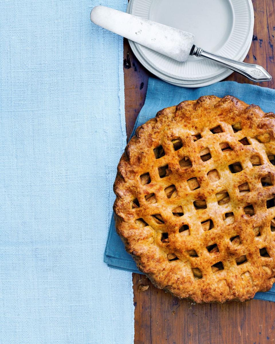 cheddar apple pie with a lattice crust top on a blue linen napkin