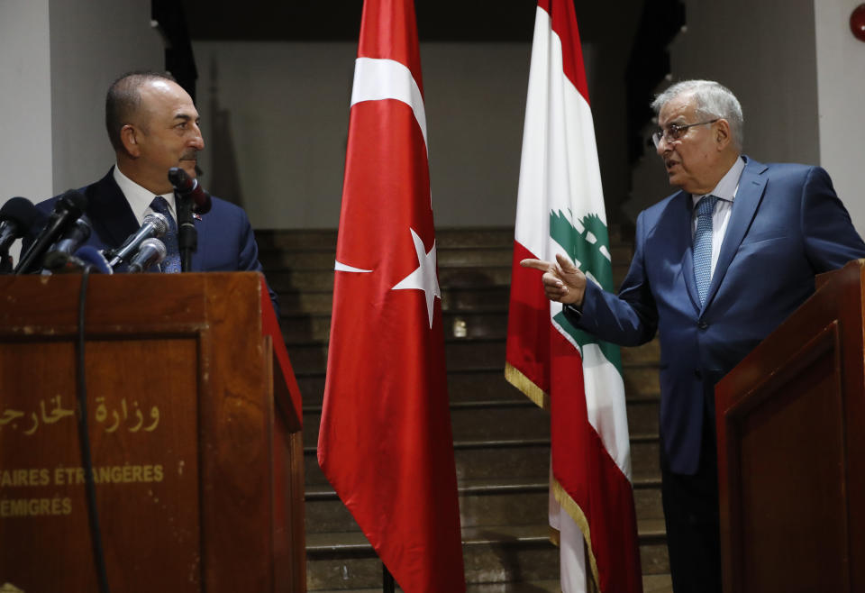 Turkey's Foreign Minister Mevlut Cavusoglu, left, listens to his Lebanese counterpart Abdallah Bou Habib during a joint press conference, at the Lebanese foreign ministry, in Beirut, Lebanon, Tuesday, Nov. 16, 2021. Cavusoglu is in Beirut to meet and sign agreements with Lebanese officials. (AP Photo/Hussein Malla)