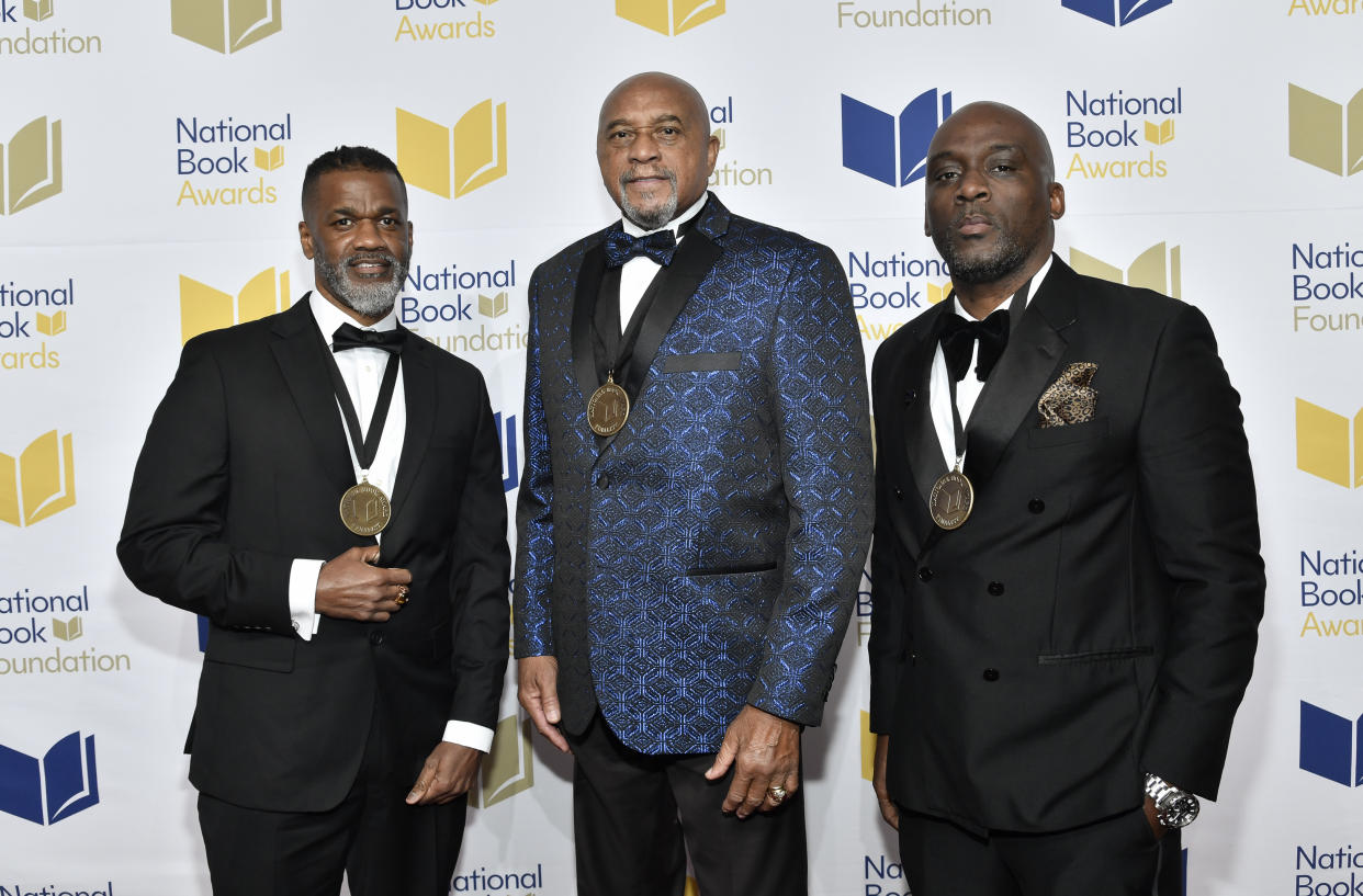 Young People's Literature finalists Dawud Anyabwile, left, Tommie Smith and Derrick Barnes, right, attend the 73rd National Book Awards ,at Cipriani Wall Street on Wednesday, Nov. 16, 2022, in New York. (Photo by Evan Agostini/Invision/AP)