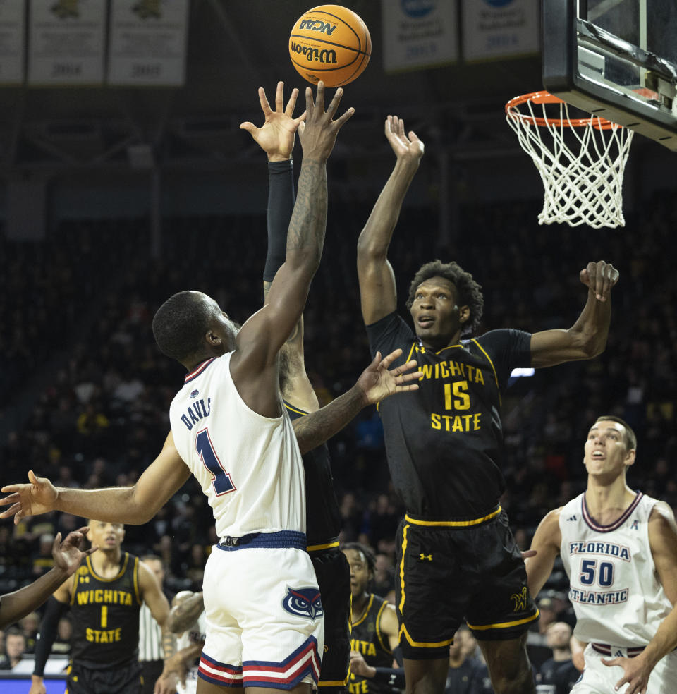 Florida Atlantic's Johnell Davis shoot against Wichita State defender Quincy Ballards during the first half of an NCAA college basketball game on Sunday, Feb., 11, 2024, in Wichita, Kan. (Travis Heying/The Wichita Eagle via AP)