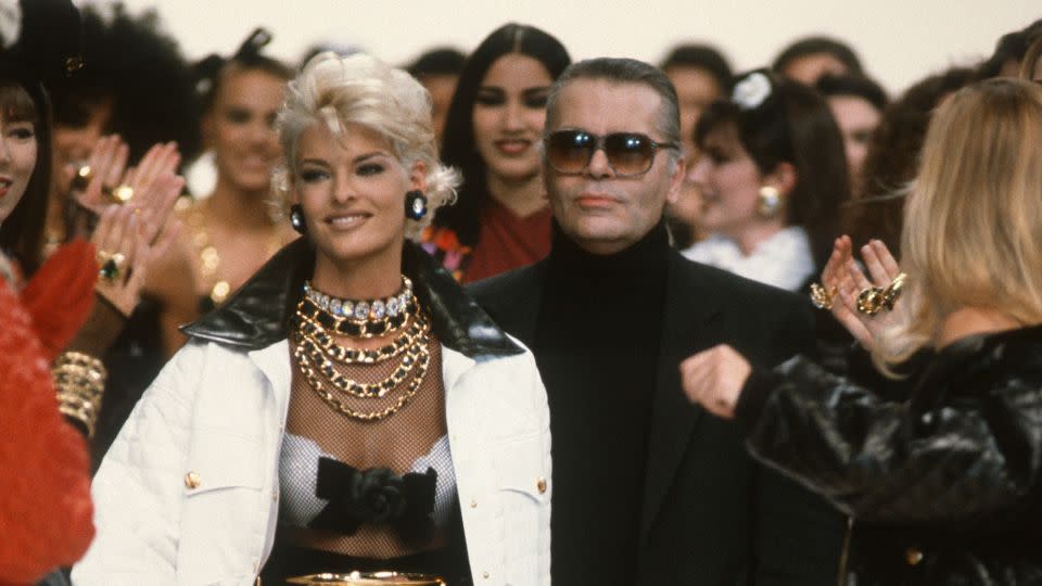 Linda Evangelista and Karl Lagerfeld (center) walk the runway during the finale of Chanel's 1991 Fall-Winter fashion show in Paris, France. - Victor Virgile/Gamma-Rapho/Getty Images