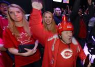 Fans celebrate a goal during Team Canada's gold medal win over Sweden in their men's ice hockey game at the Sochi 2014 Winter Olympic Games, at a gathering in Toronto February 23, 2014. REUTERS/Aaron Harris (CANADA - Tags: SPORT OLYMPICS ICE HOCKEY)