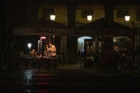 People sit in a terrace of a bar in downtown Madrid, Spain, Friday, Oct. 23, 2020. (AP Photo/Manu Fernandez)