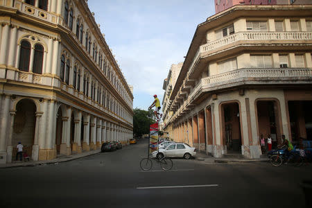 Felix Guirola, 52, rides a homemade bike with an advertising banner in Havana, Cuba, July 20, 2016. REUTERS/Alexandre Meneghini