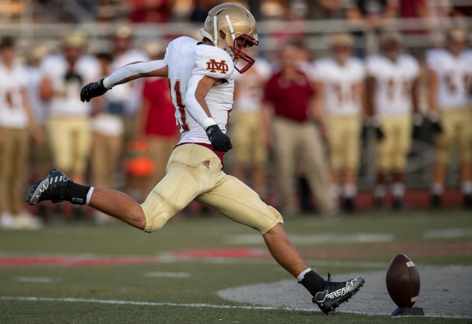 Mater Dei's Tanner Halbig (21) kicks off the Memorial Tigers vs Mater Dei Wildcats game at Enlow Field Friday, Sept. 8, 2023.