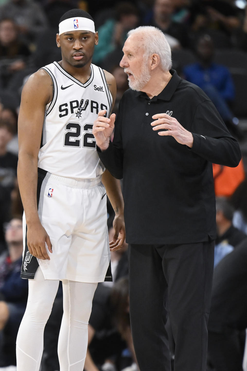 San Antonio Spurs head coach Gregg Popovich, right, speaks with Spurs guard Malaki Branham during the first half of an NBA basketball game against the Memphis Grizzlies, Saturday, Nov. 18, 2023, in San Antonio. (AP Photo/Darren Abate)