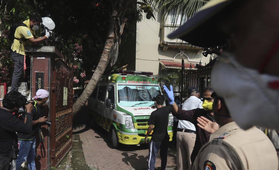 An ambulance carrying the body of Bollywood actor Sushant Singh Rajput leaves from the building he lived in Mumbai, India, Sunday, June 14, 2020. Rajput was found dead at his Mumbai residence on Sunday, police and Indian media reports said. (AP Photo/Rafiq Maqbool)