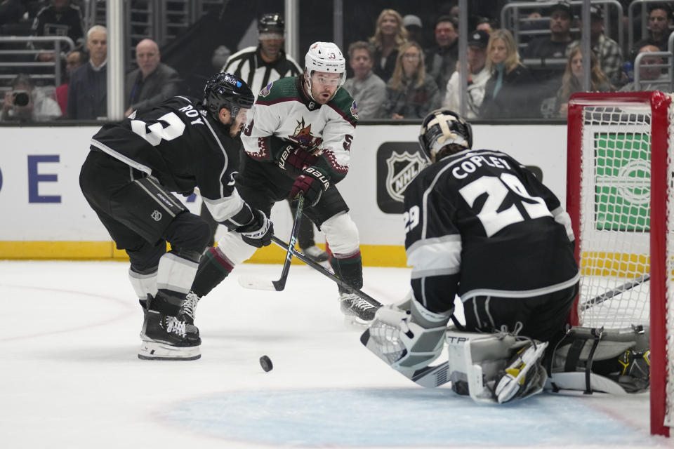 Arizona Coyotes left wing Michael Carcone (53) shoots against Los Angeles Kings defenseman Matt Roy (3) and goaltender Pheonix Copley (29) during the first period of an NHL hockey game Tuesday, Oct. 24, 2023, in Los Angeles. (AP Photo/Ashley Landis)