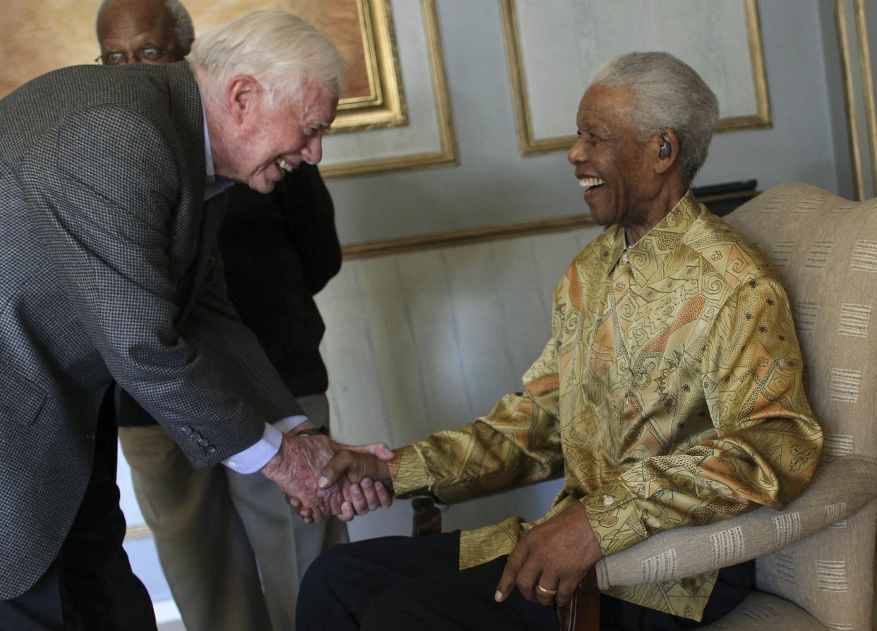 Former South African President Nelson Mandela, right, is greeted by former President Jimmy Carter during a reunion with The Elders on May 29, 2010, in Johannesburg, South Africa.