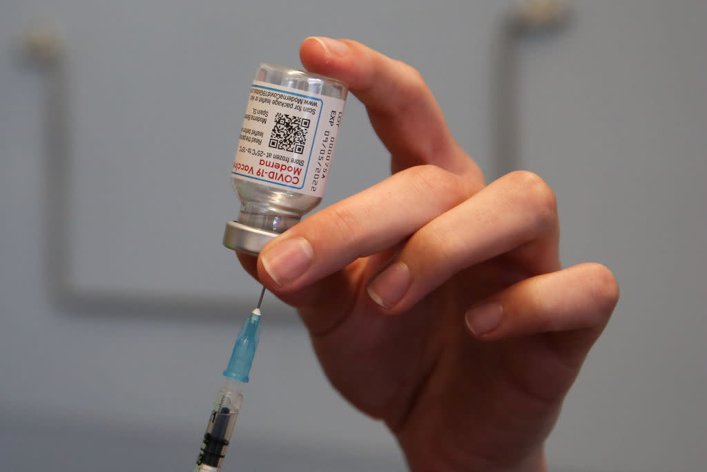 A health worker draws the Moderna COVID-19 vaccine  as she