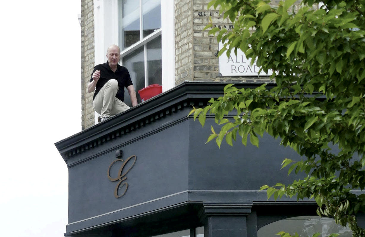 Actor Ade Edmondson has been pictured hitting rock bottom after being rescued by fire crews - for getting stuck while cleaning his windows. (Duncan Cumming/SWNS)