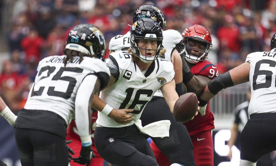 Nov 26, 2023; Houston, Texas, USA; Jacksonville Jaguars quarterback Trevor Lawrence (16) drops back with the ball during the third quarter against the Houston Texans at NRG Stadium. Mandatory Credit: Troy Taormina-USA TODAY Sports