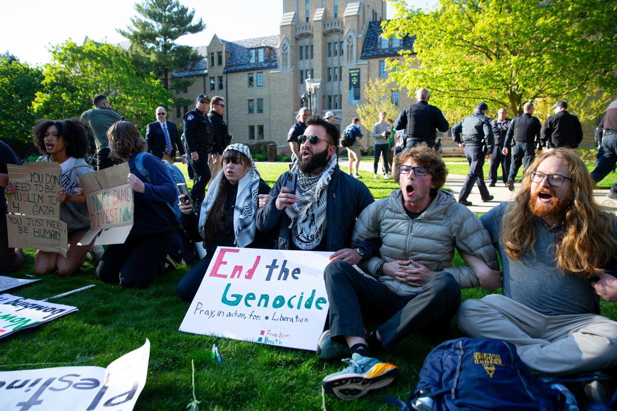 Jaryán Hernández, center, locks arms with other protesters during a pro-Palestinian protest on the University of Notre Dame's campus on Thursday, April 25, 2024.