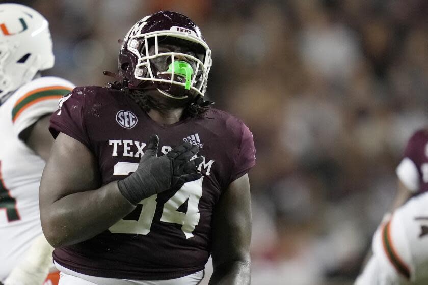 Texas A&M defensive lineman Isaiah Raikes (34) reacts after tackling a Miami running back.