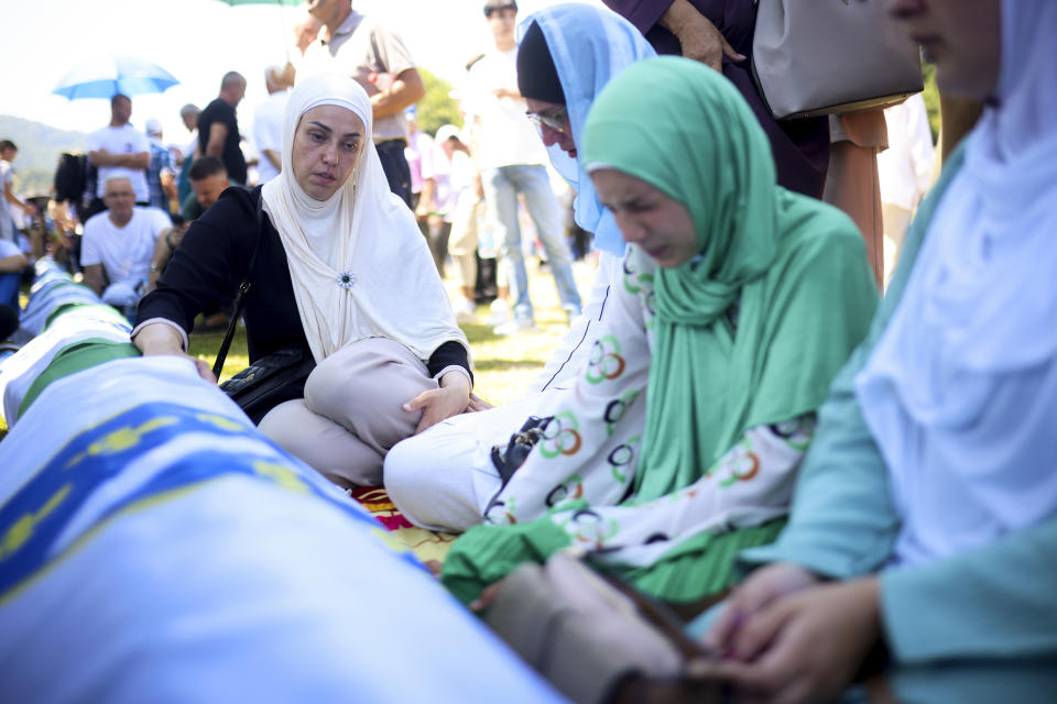 A Bosnian muslim woman mourns next to the coffin of her relative, newly identified victim of the Srebrenica genocide, at the Srebrenica Memorial Centre, in Potocari, Bosnia, Thursday, July 11, 2024. Thousands gather in the eastern Bosnian town of Srebrenica to commemorate the 29th anniversary on Monday of Europe's only acknowledged genocide since World War II. (AP Photo/Armin Durgut)