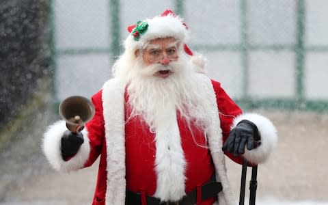 Father Christmas arrives at Kensington Palace - Credit: PA