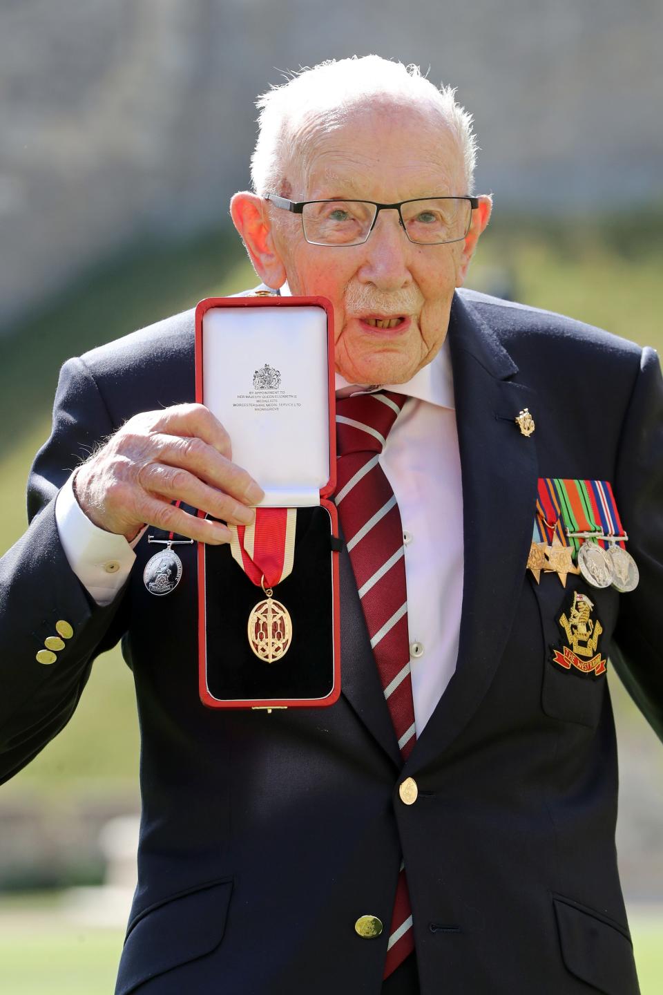 Captain Sir Thomas Moore poses after being awarded with the insignia of Knight Bachelor by Queen Elizabeth II at Windsor Castle on July 17, 2020 in Windsor.