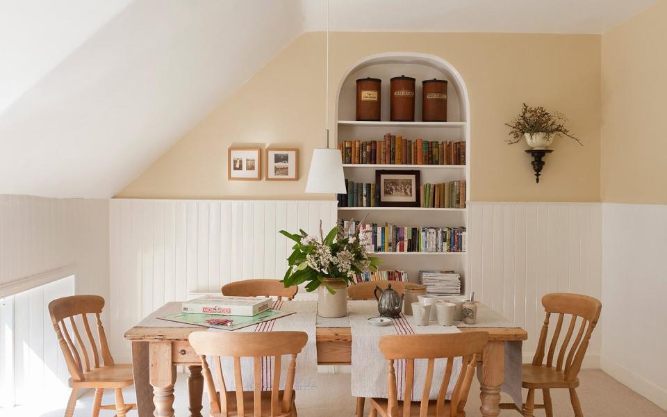 a dining room with a table and chairs