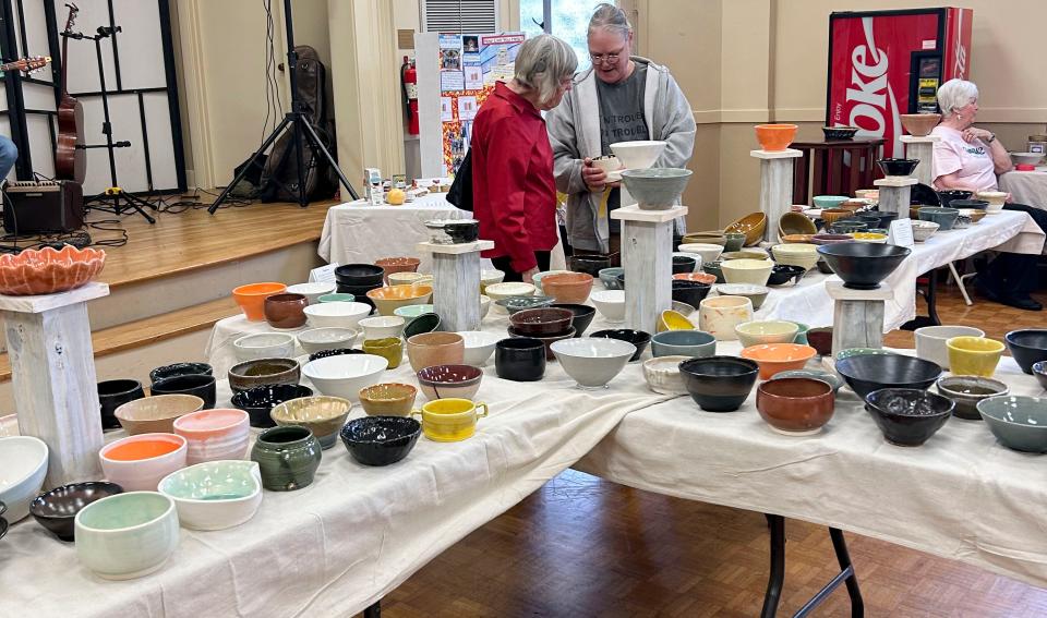 Patrons examine the bowls on March 20, 2024, at Grace Presbyterian Church's Empty Bowls fundraiser in Tuscaloosa.