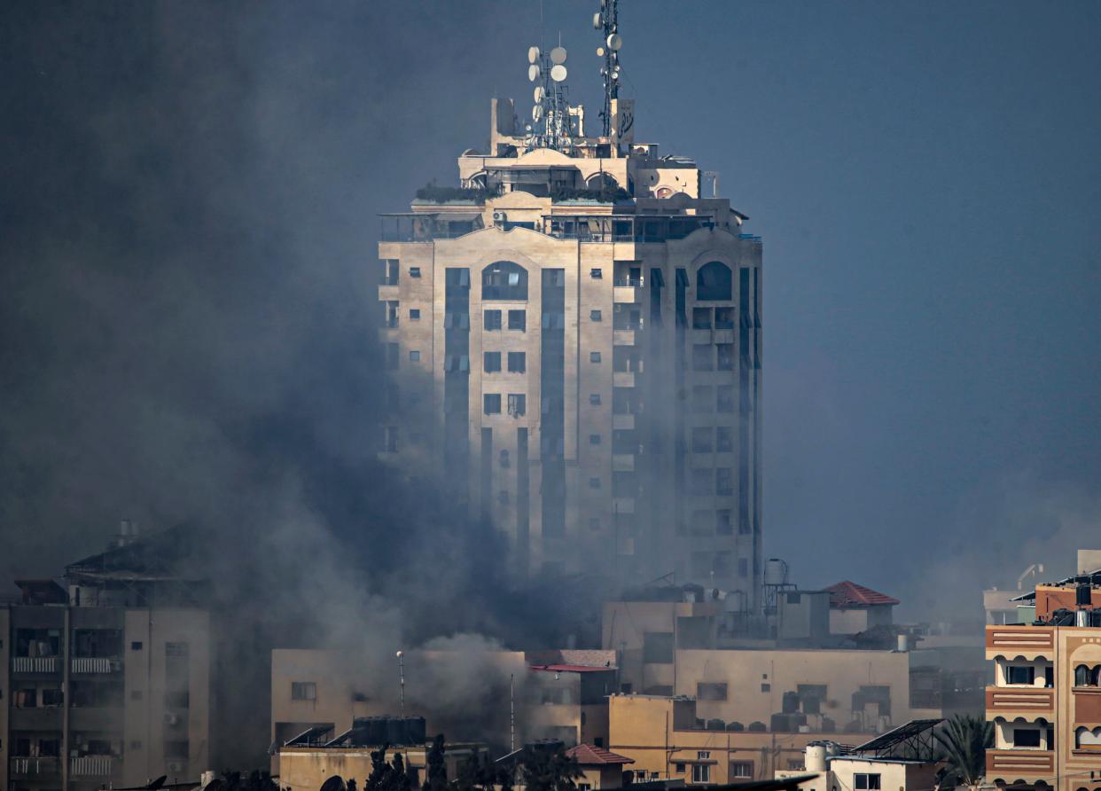 A high-rise building is obscured by smoke in Gaza following airstrikes (AP)