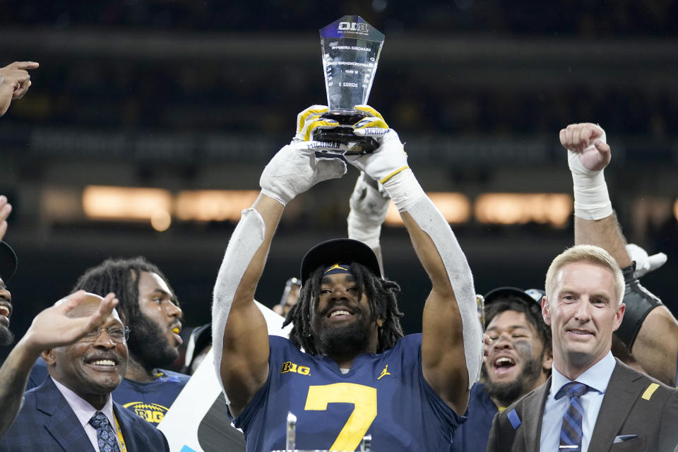 Michigan running back Donovan Edwards holds the most valuable player trophy after defeating Purdue in the Big Ten championship NCAA college football game, early Sunday, Dec. 4, 2022, in Indianapolis. Michigan won, 43-22. (AP Photo/Michael Conroy)